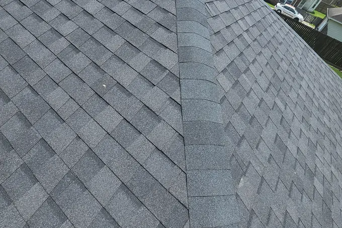 Gray asphalt shingles along a roof hip