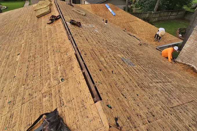 Exposed roof decking and roofing tools during work